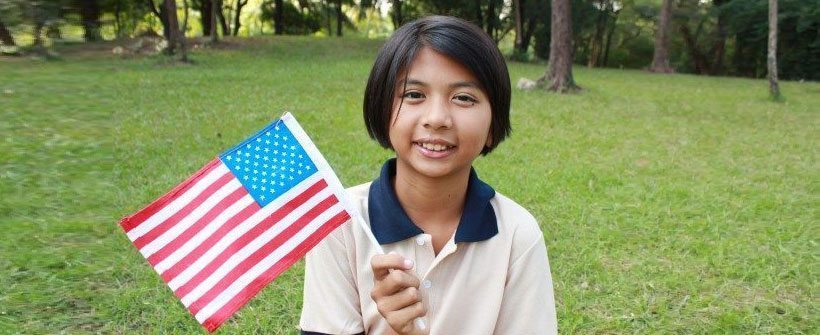child holding american flag